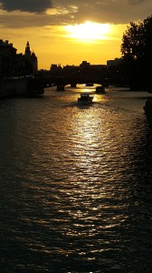 A bateau mouche plies its romantic route under the bridges at  sunset       